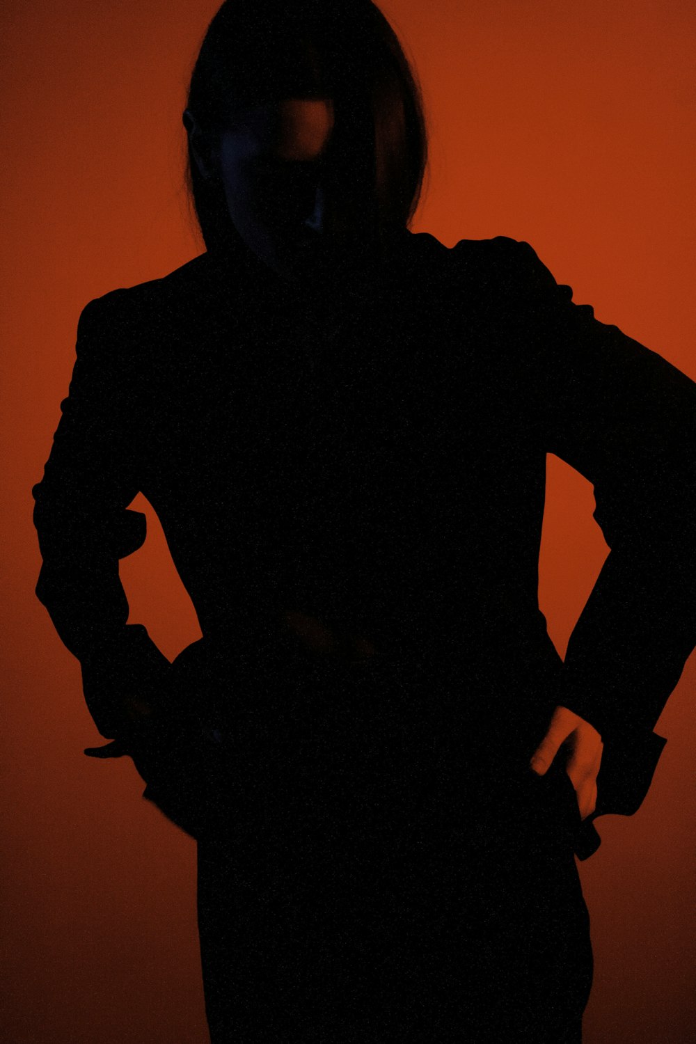 a silhouette of a person with their hands on their hips