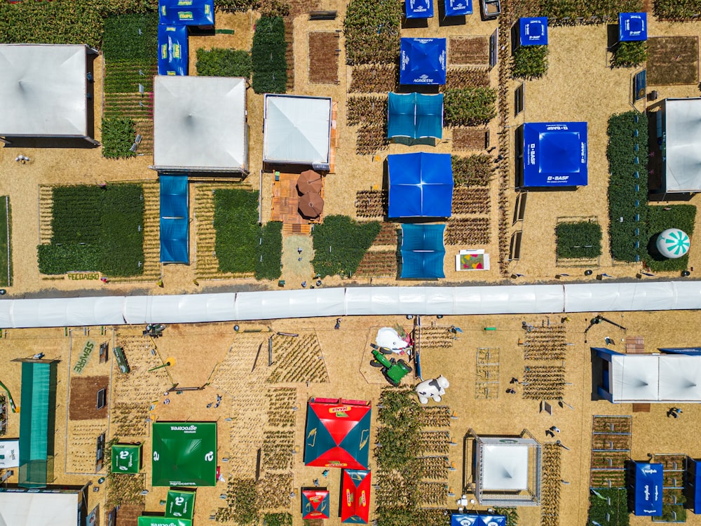 an aerial view of a field with blue and green chairs