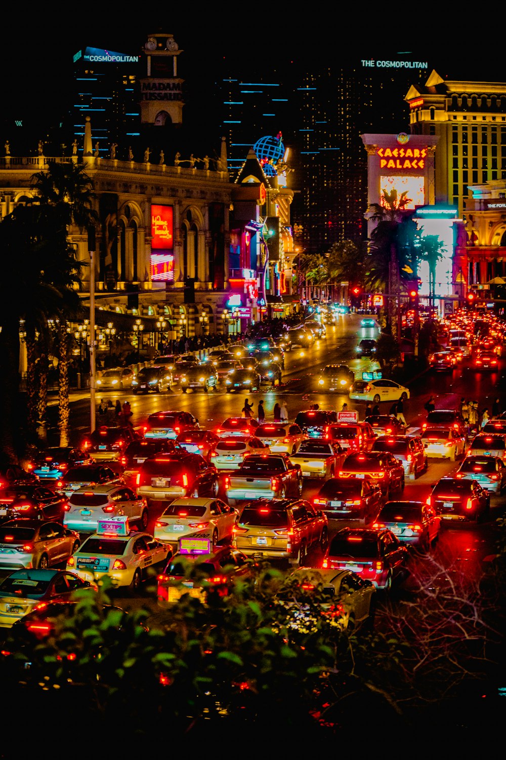 a city street filled with lots of traffic at night