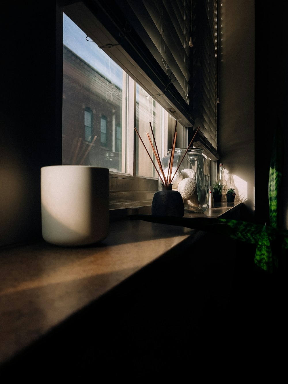 a window sill with a plant in a vase next to it