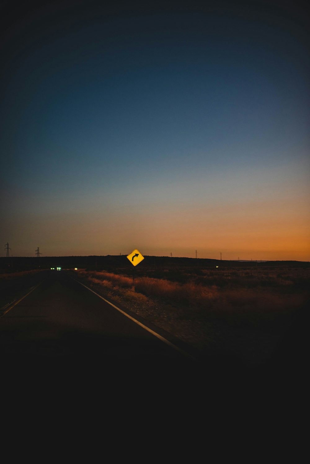 a yellow sign sitting on the side of a road