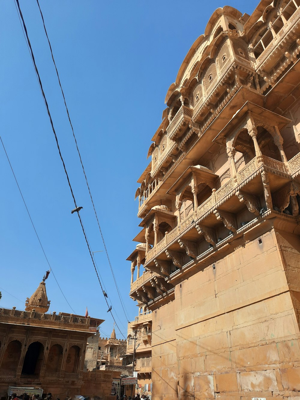 a tall building with many balconies on top of it