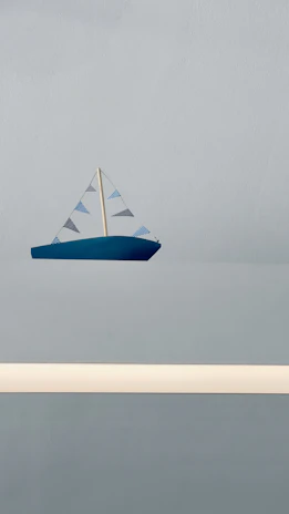 Designer sketching a minimalist RC sailboat on a digital tablet