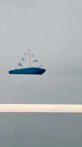 Designer sketching a minimalist RC sailboat on a digital tablet