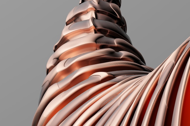 A complex structure of smooth, interwoven layers that resemble sheets or ribbons in varying shades of copper and brown, creating a visually intriguing and abstract form. The surface is glossy and features subtle texture, giving it a metallic and polished appearance.