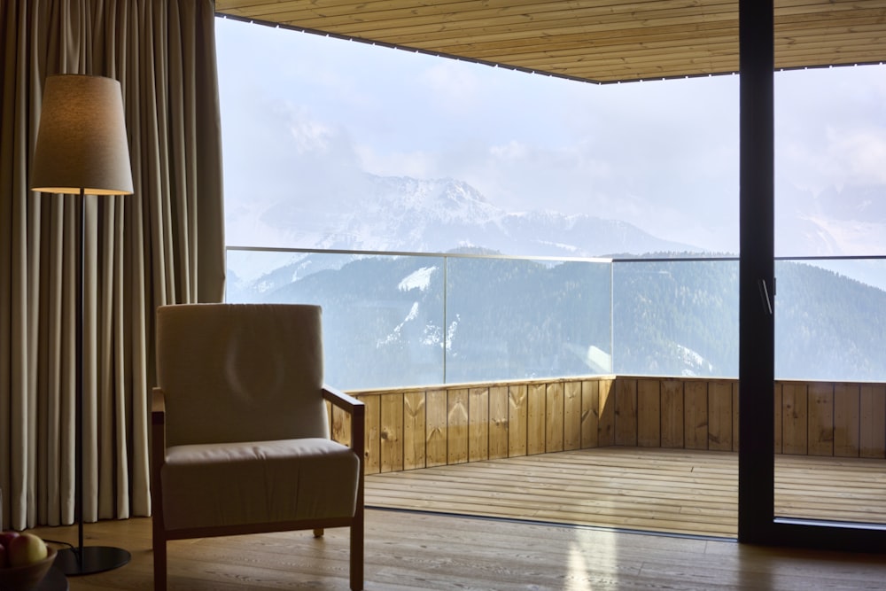 a chair sitting in a living room next to a window