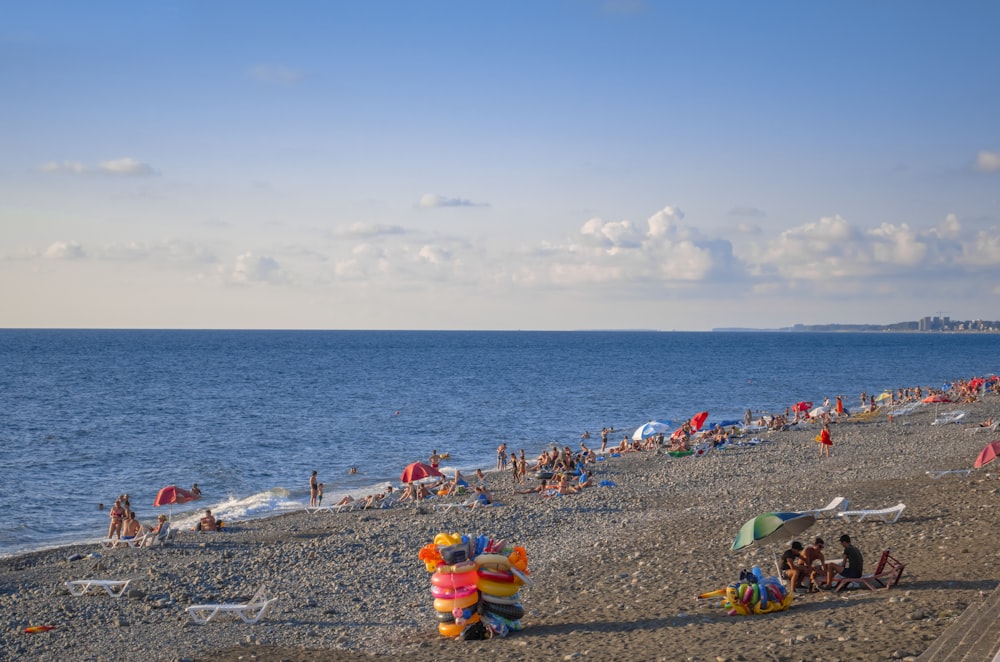 a beach filled with lots of people and umbrellas