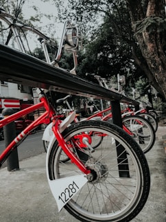 a row of red bikes parked next to each other