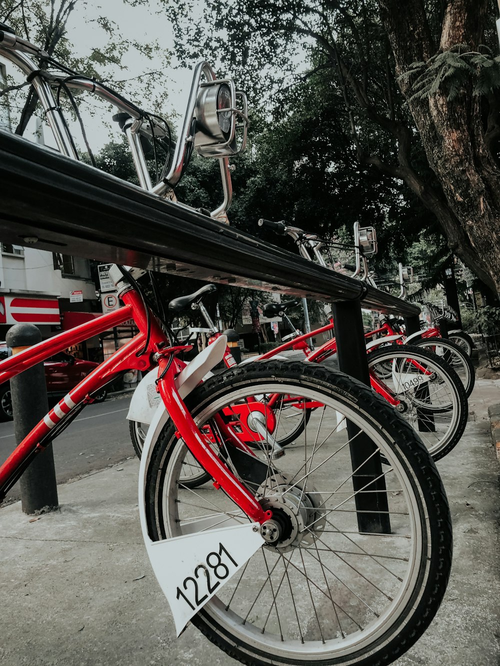 a row of red bikes parked next to each other