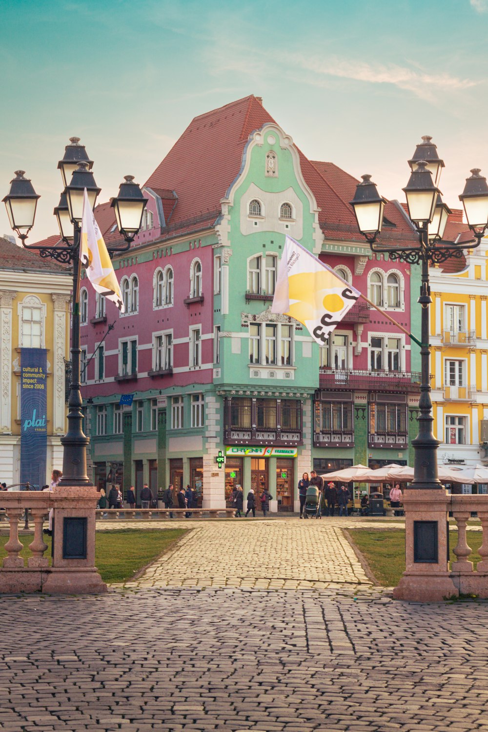 a group of buildings with flags flying in front of them