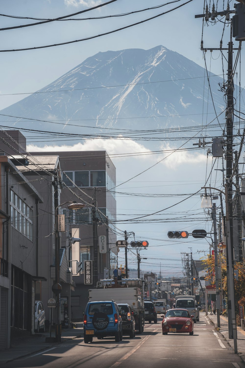 a city street with a mountain in the background