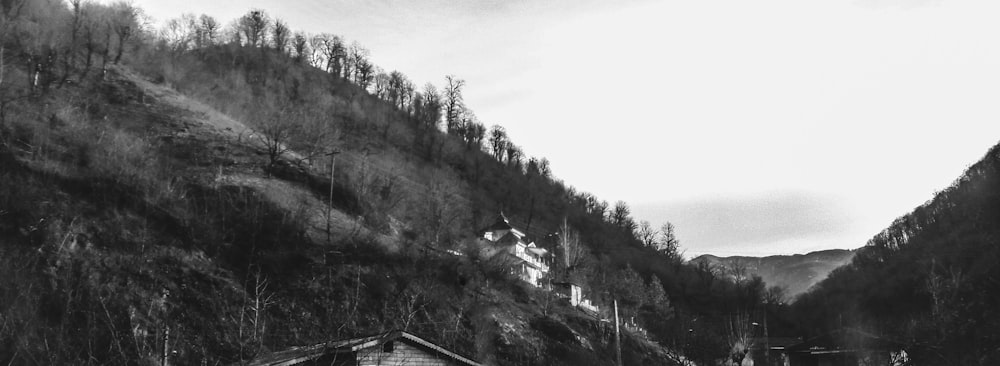 a black and white photo of a cabin in the mountains