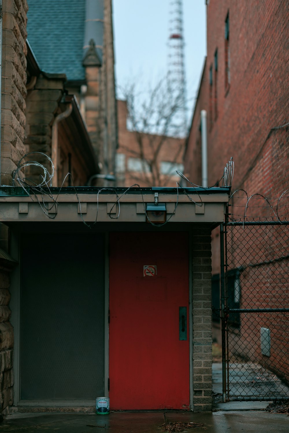 a red door in front of a brick building