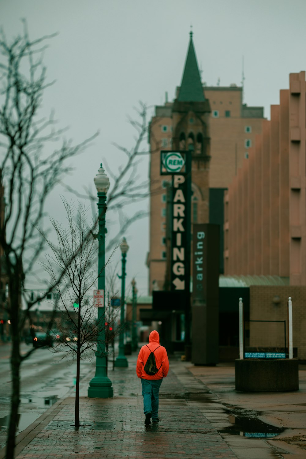 a person in a red jacket is walking down the street