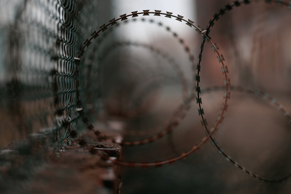 a close up of a fence with barbed wire