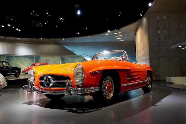 A sleek salvaged sedan ready for restoration under bright showroom lights