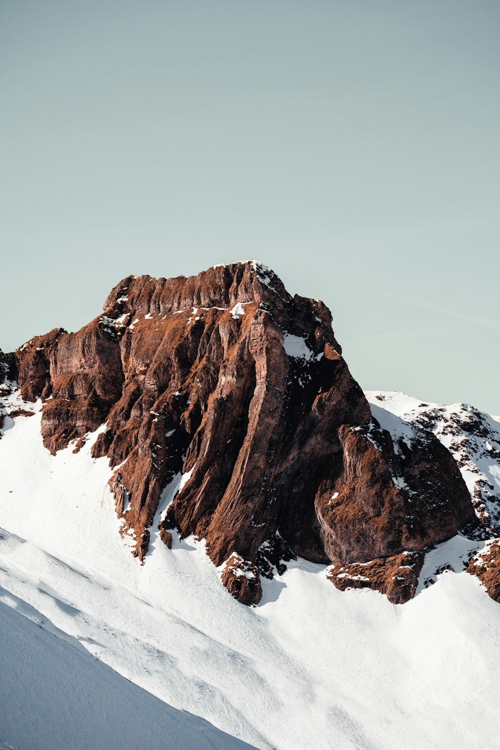 a man riding skis down the side of a snow covered mountain