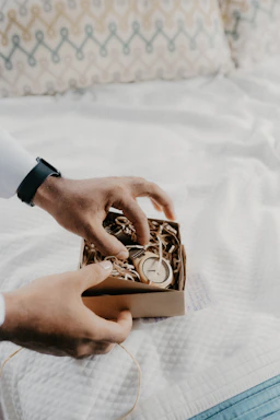 A customer carefully packing a vintage watch to return it in its original box.