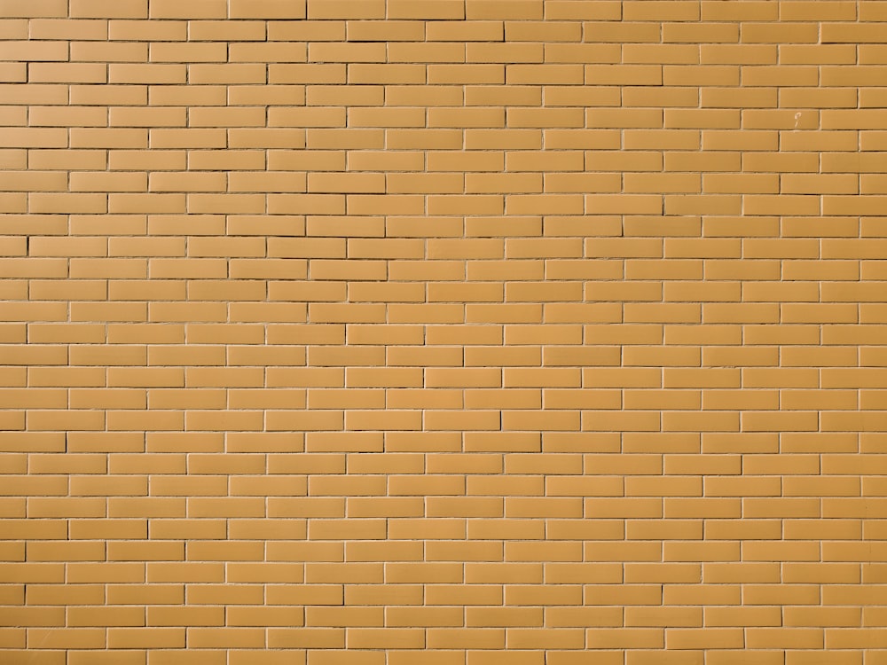 a yellow brick wall with a red stop sign