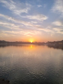 A gentle sunrise over calm water, symbolizing new beginnings and inner peace.