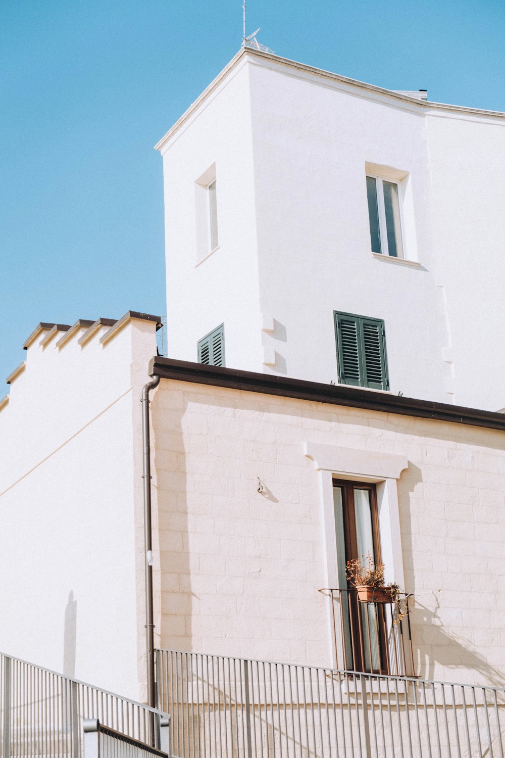 a tall white building with a clock on it's side