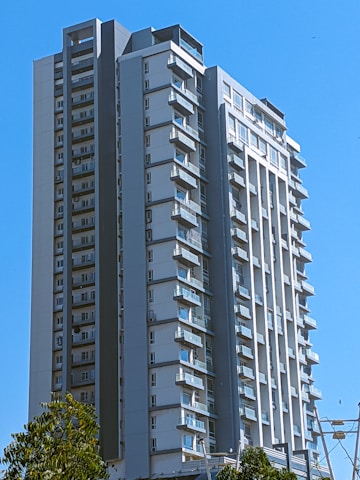 Sleek high-rise apartment building overlooking Erbil’s vibrant cityscape.