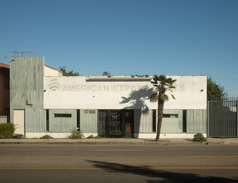 a building with a palm tree in front of it