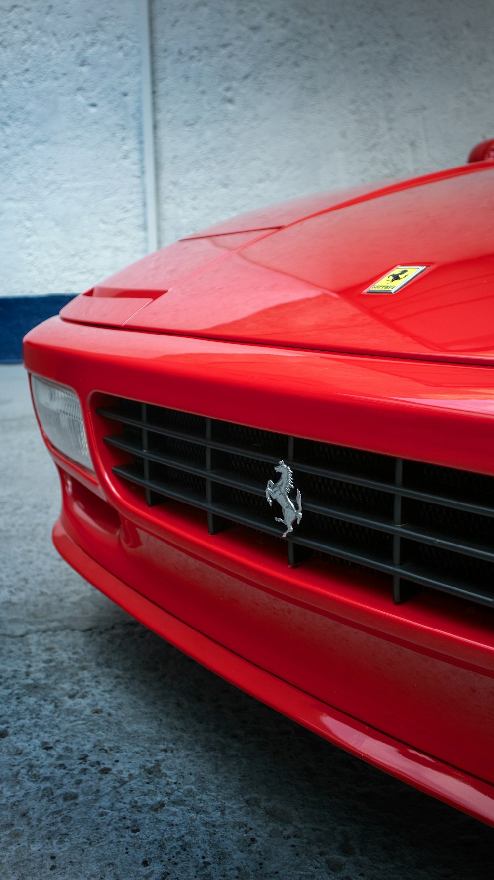 a red ferrari sports car parked in a garage