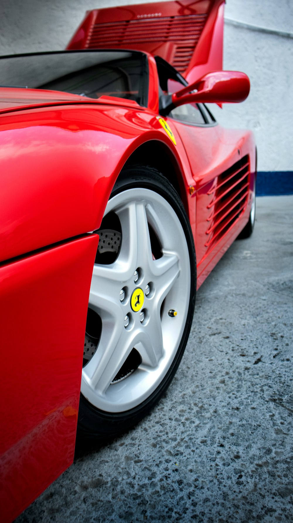 a red sports car parked in a parking lot