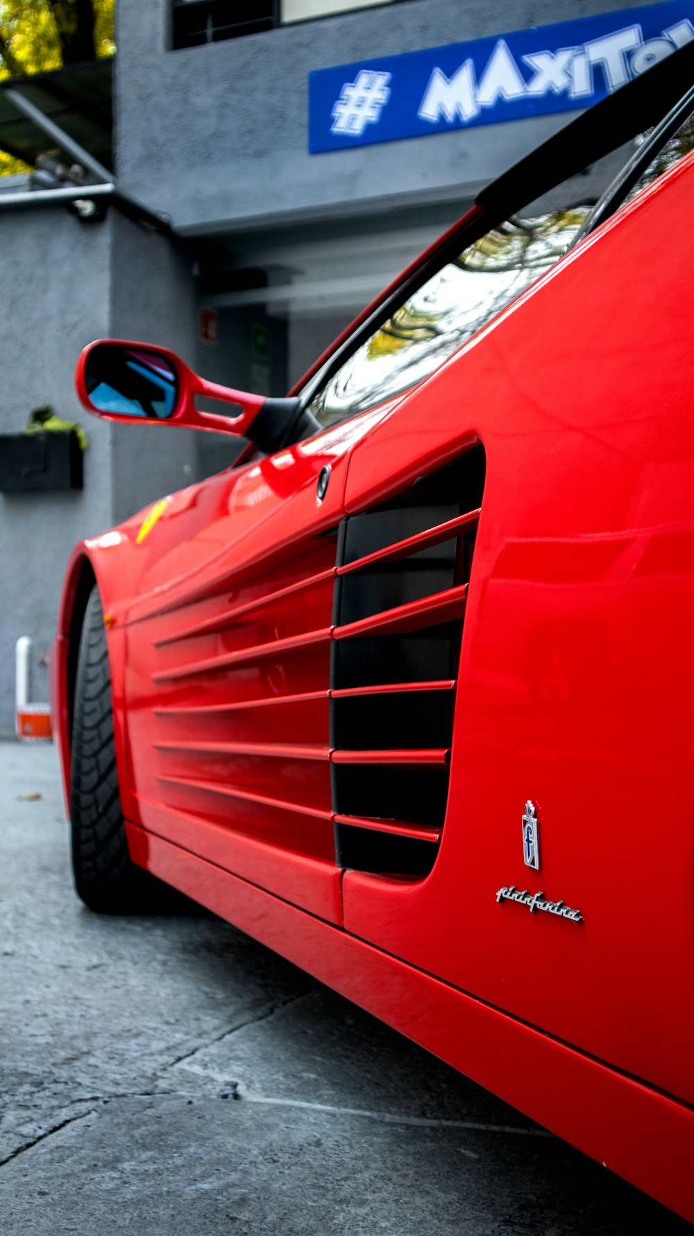 a red sports car parked in front of a building