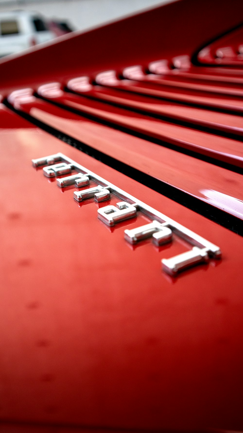 a close up of the emblem on a red car