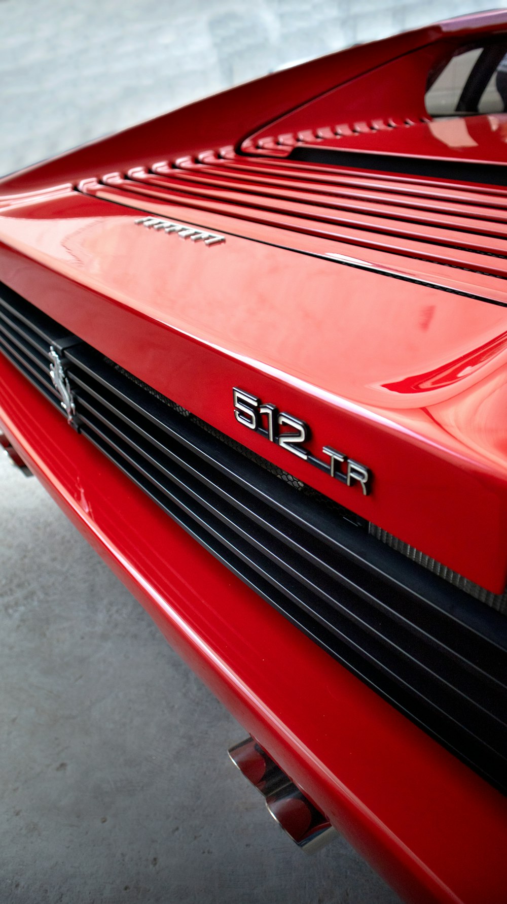 a close up of the hood of a red sports car