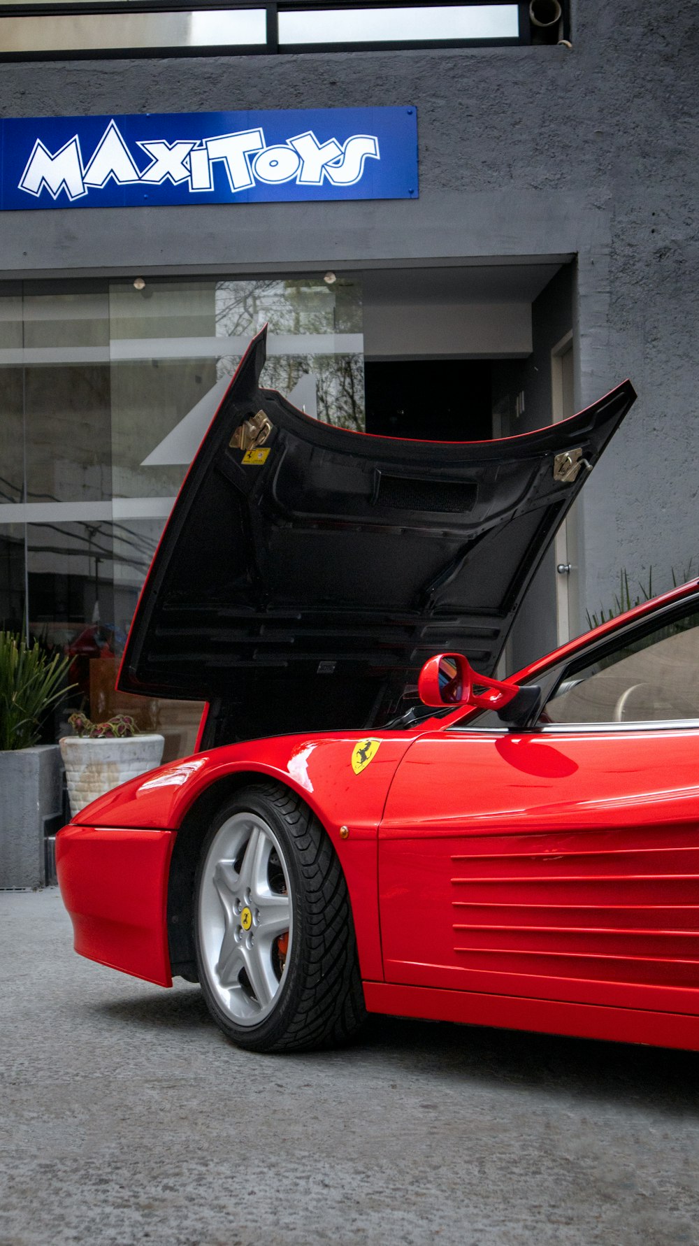 a red sports car with its hood open