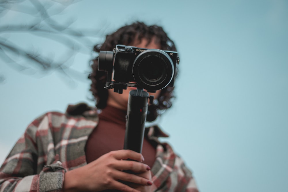 a man holding a camera in his hands