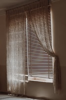 Blackout room divider curtains hanging in a cozy, softly lit room