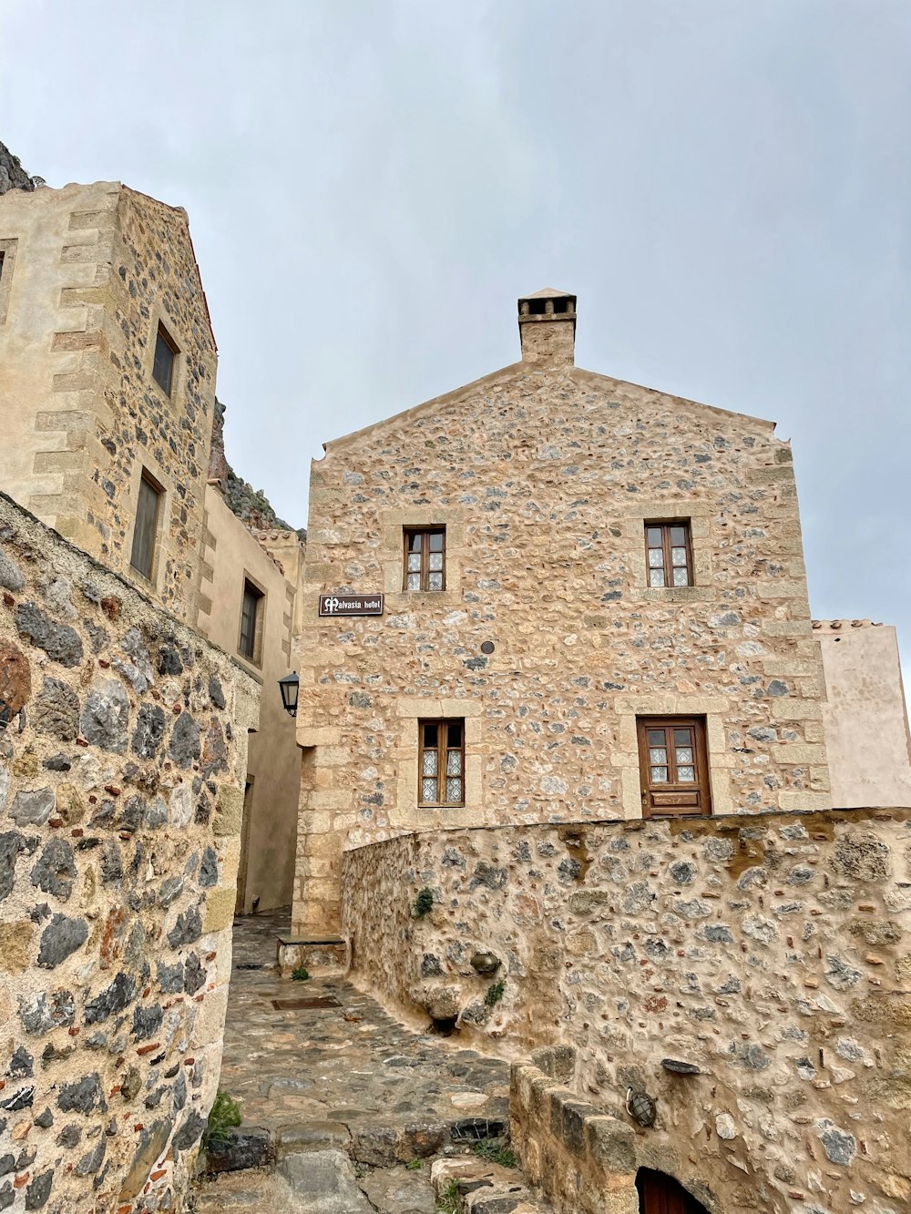 a stone building with a clock on the top of it