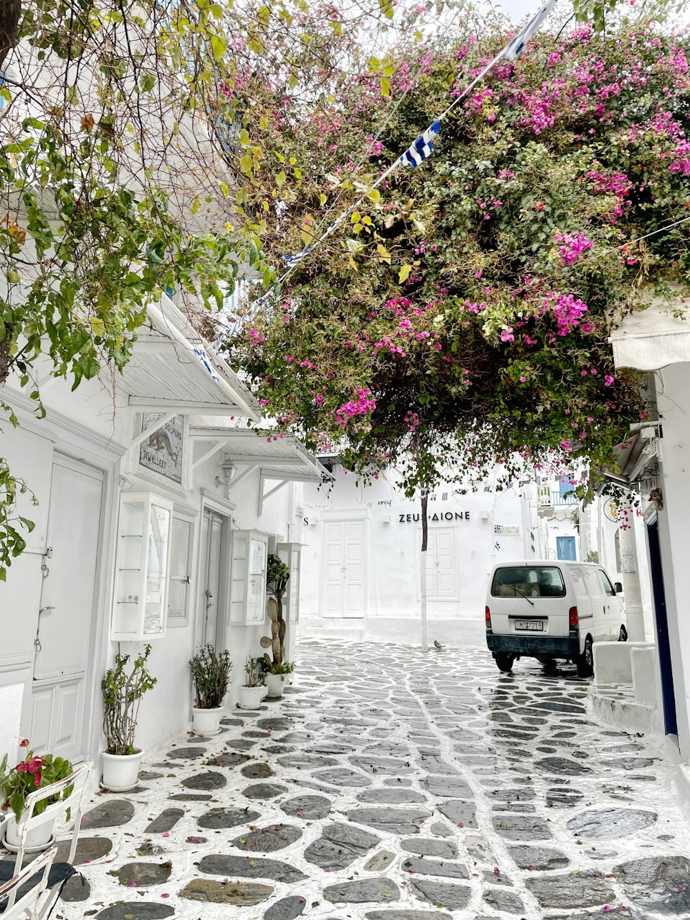 a car is parked on a cobblestone street