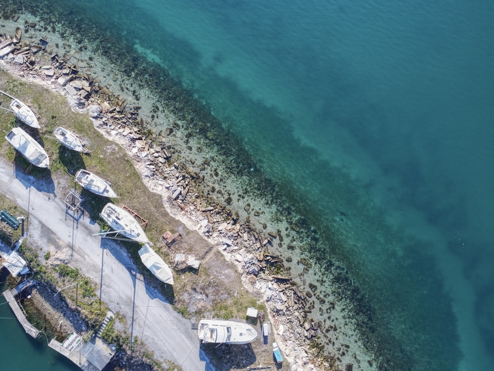 an aerial view of several boats docked at a pier