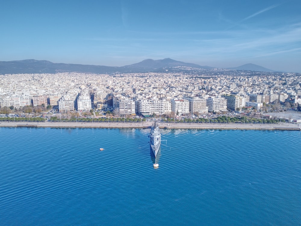 a large body of water with a city in the background