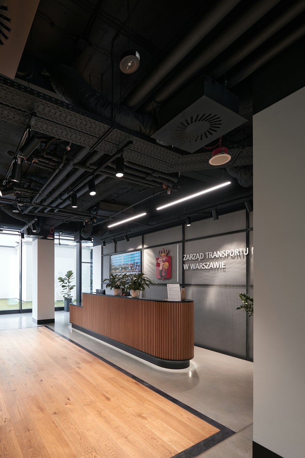 an empty office with a wooden reception desk