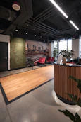 A sleek office reception area with the güvenyalı logo subtly displayed on a textured wall.