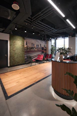 A welcoming office reception area with a modern design and the Ze Property Management logo visible.