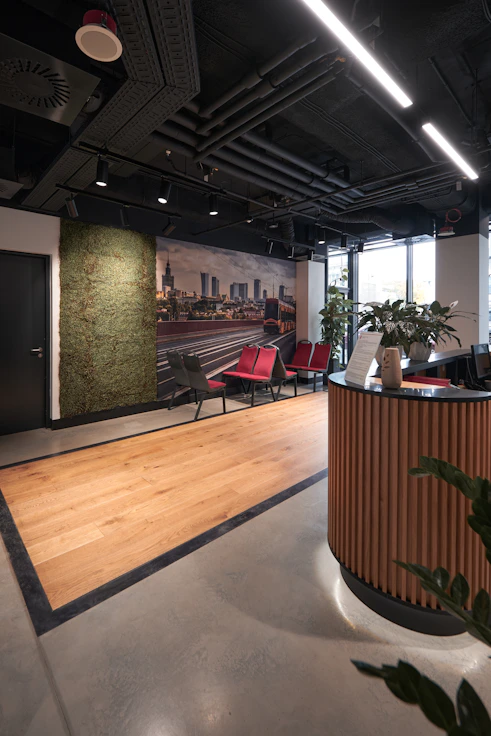 A sleek, modern office reception area with deep blue and brushed gold accents reflecting a high-end industrial design.