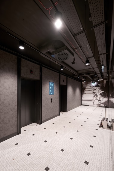 a room with a tiled floor and two elevators