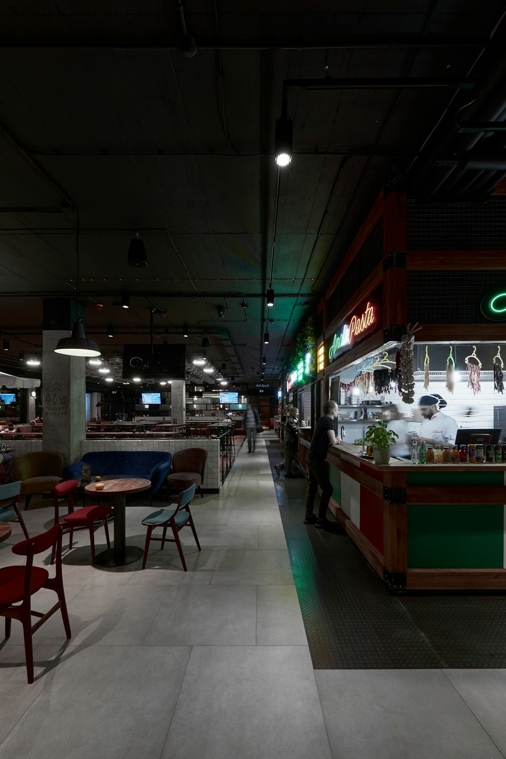 a restaurant filled with lots of tables and chairs