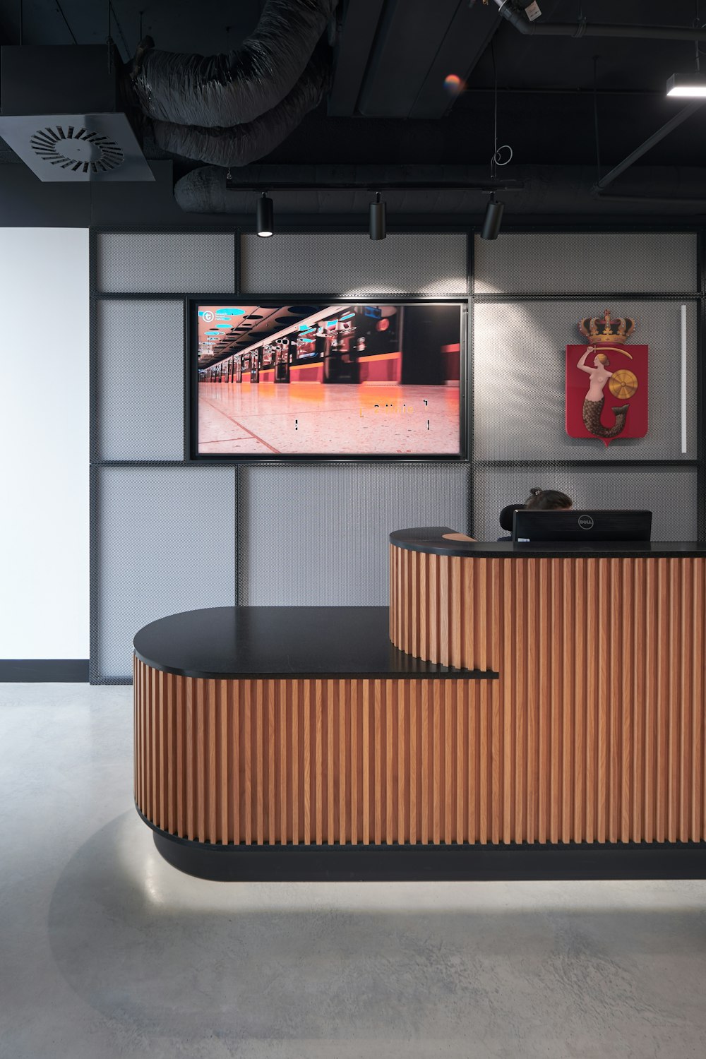 a reception area with a curved wooden counter
