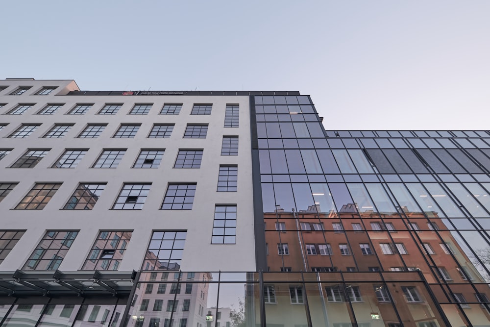 a tall building with lots of windows next to other buildings