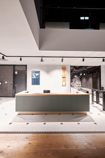 a room with a large desk in the middle of it