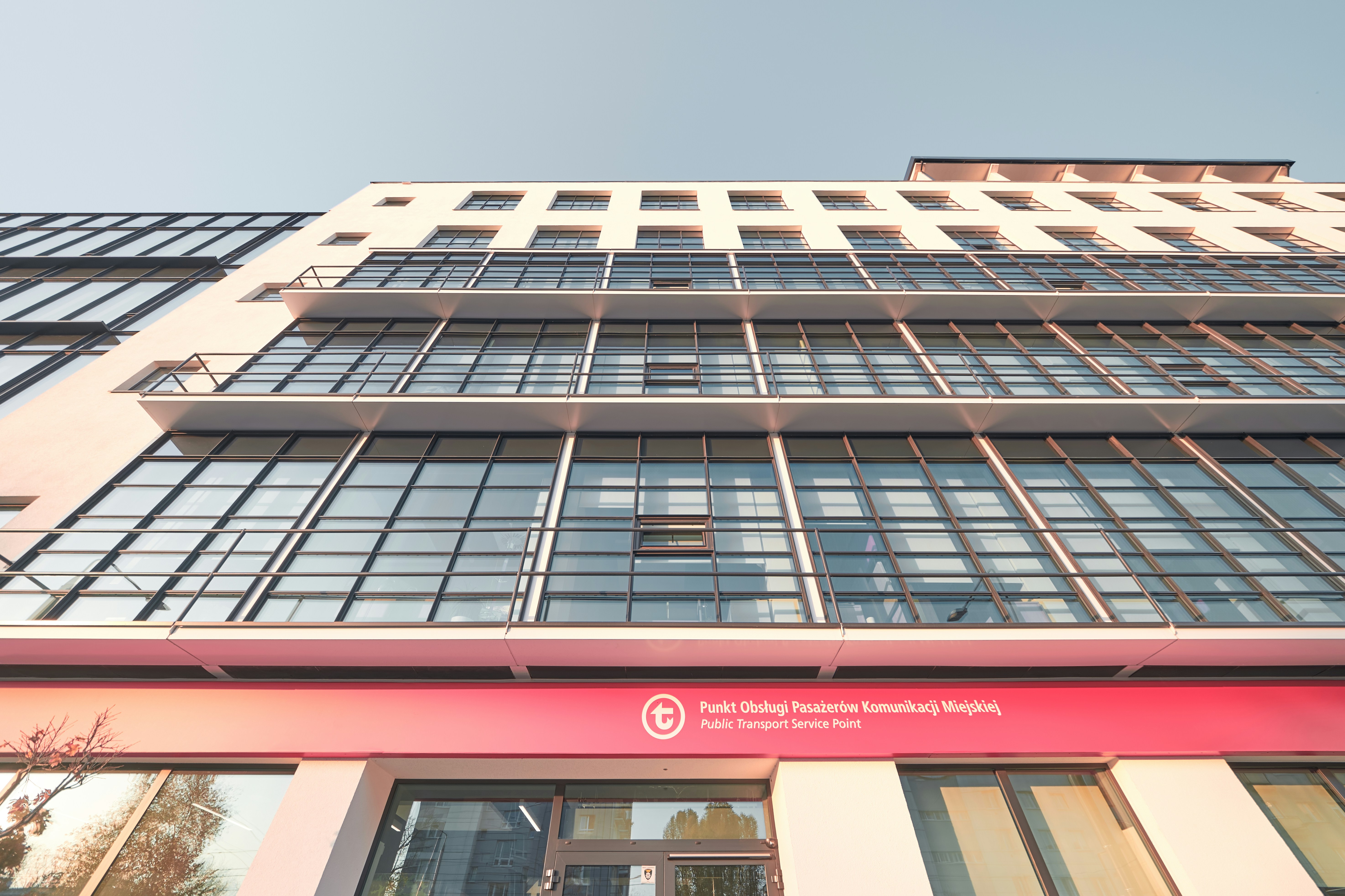 a tall building with lots of windows and a red sign