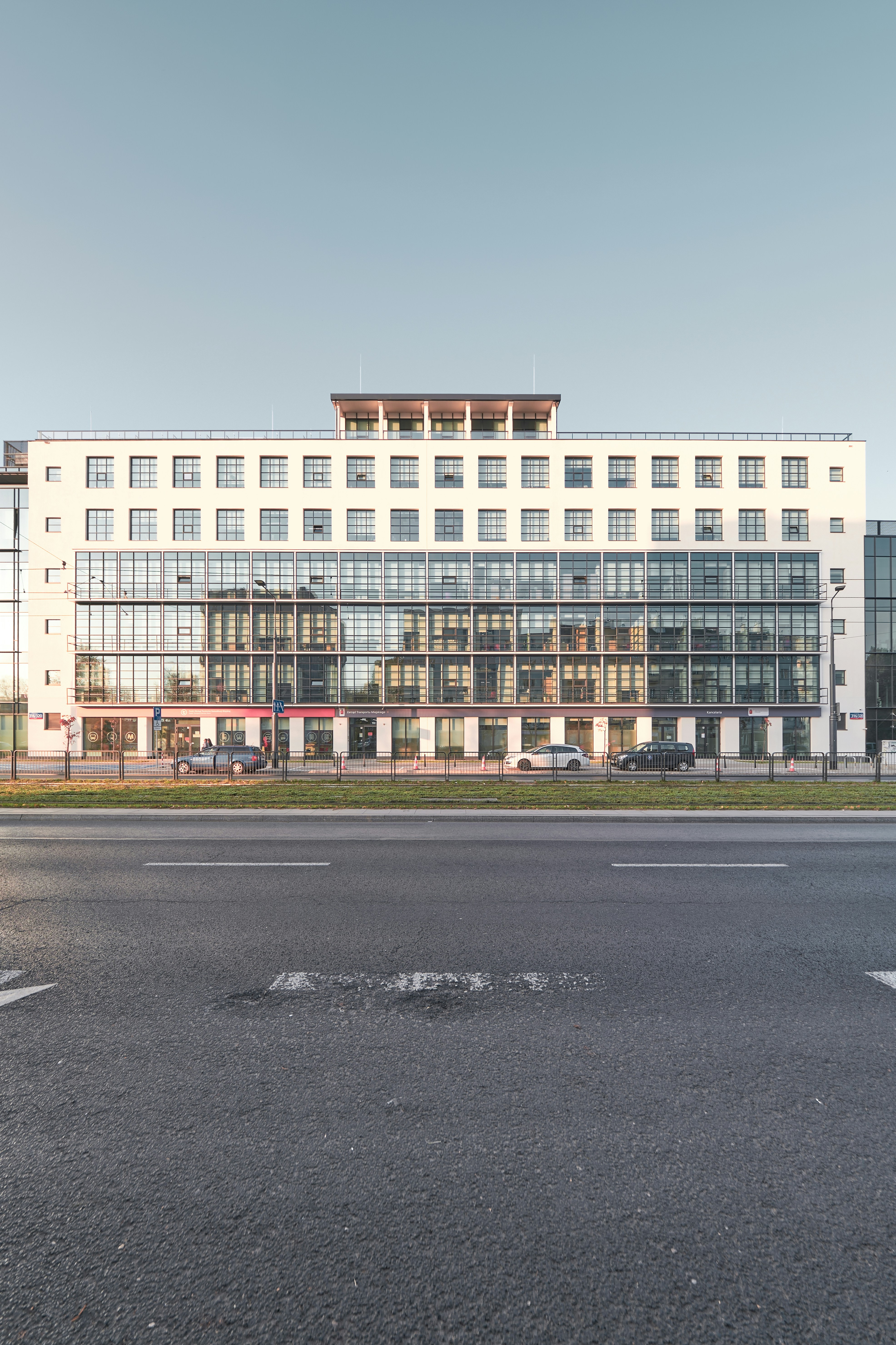 a large white building sitting on the side of a road